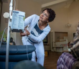 Nurse Kathy helping patient